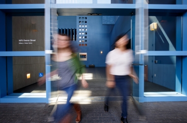 Two blurred students exiting the Rutter Center.