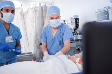 Two doctors with a patient looking at a screen.