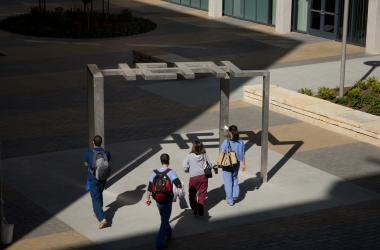 Students walk under the HEAL sculpture at the UCSF Mission Bay Campus