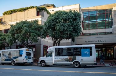 two shuttles in front of the parnassus library.