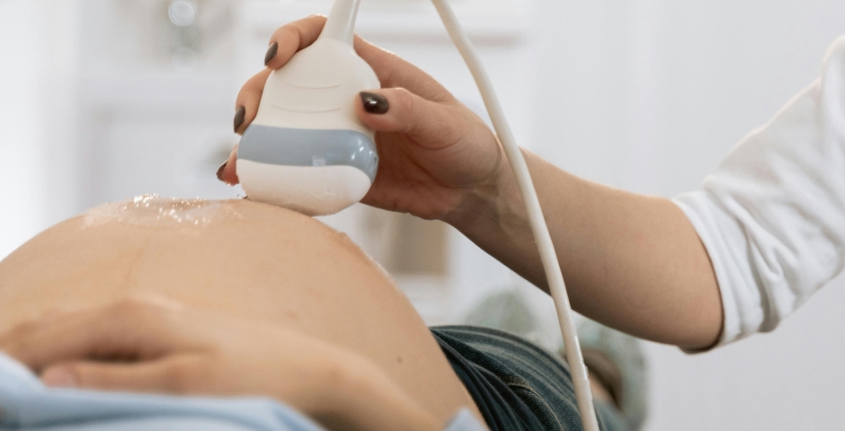 close-up of a pregnant woman lying on her back receiving an ultrasound