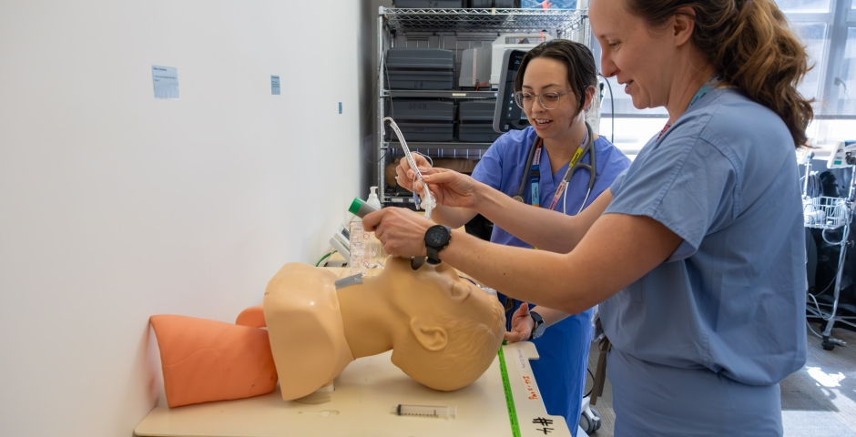 two people intubating a dummy.