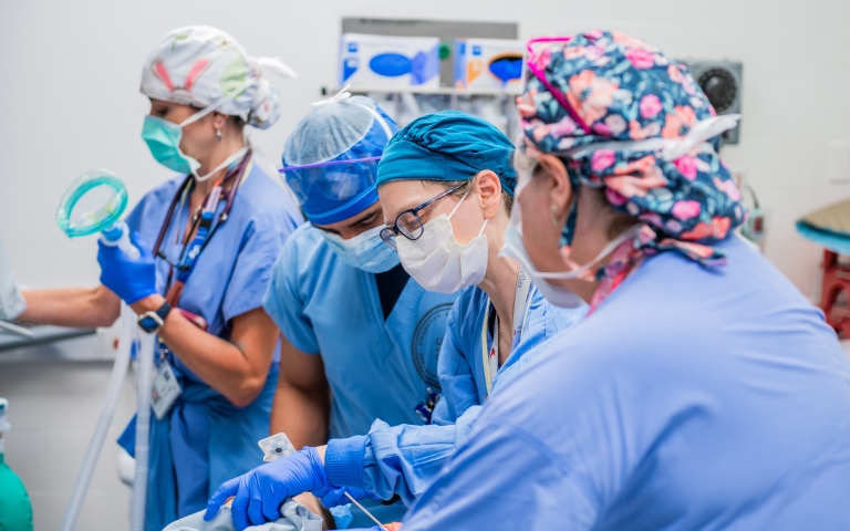 Anesthesia faculty with colleagues in the operating room