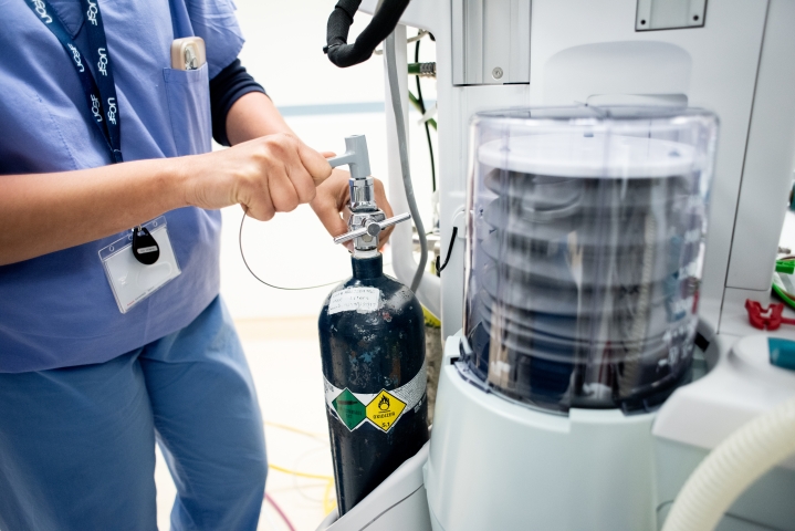 Seema Gandhi, MD, turns the valve of a smaller E-cylinder of nitrous oxide, which will still be used in OR anesthesia. 