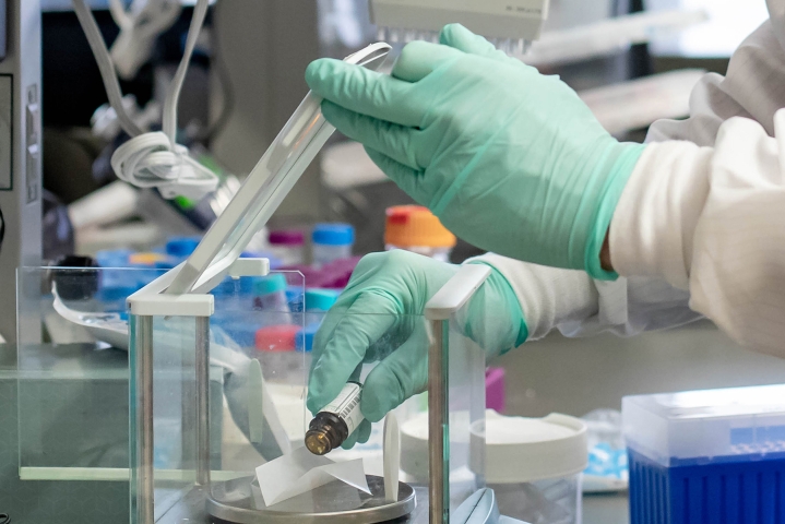 Hand wearing glove in lab