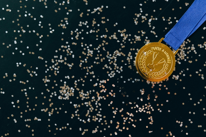 a gold medal on a black background.