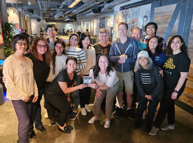 Large group of people posing and smiling in a restaurant