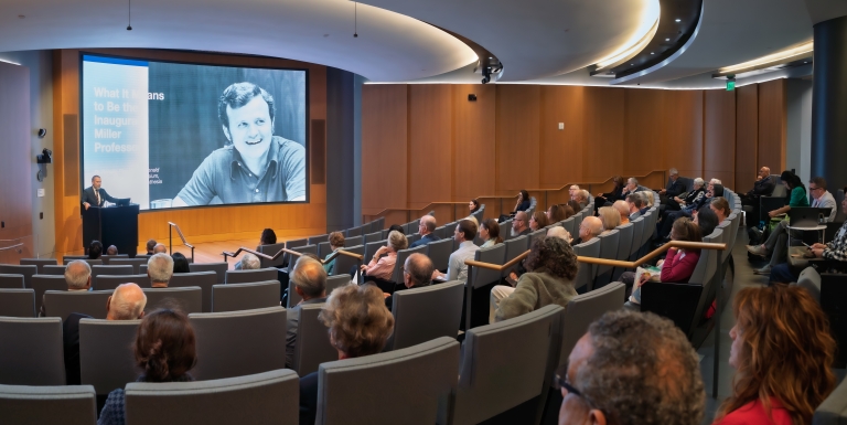 room of people watching a speaker present
