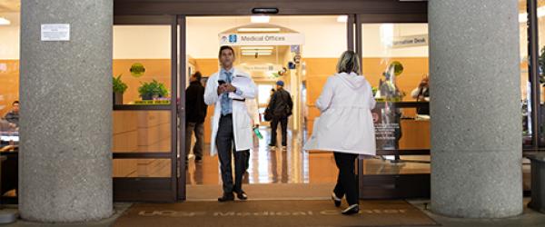 People walking through the doors of the Helen Diller Medical Center on Parnassus' Ambulatory Building