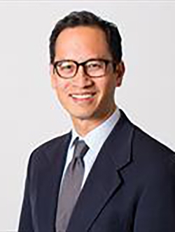 Man wearing glasses and a suit