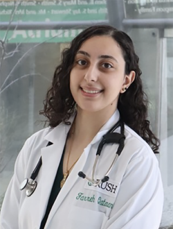 Women with curly hair wearing lab coat and stethoscope