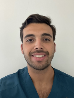 man smiling at camera in green shirt