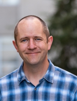 man in blue shirt smiling