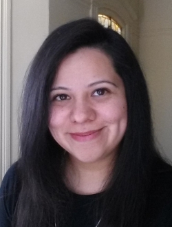 Woman with long dark hair and a dark shirt