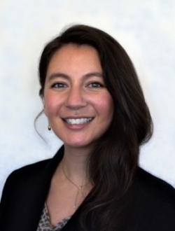 Woman with long dark hair and a dark jacket