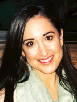 Smiling woman with long black hair.