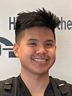 Smiling man, with short black hair.