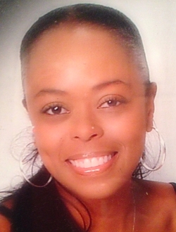 Smiling woman with tightly pulled black dark hair.