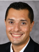 Smiling man with short black hair.