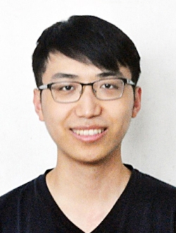 Smiling man with short black hair and glasses.