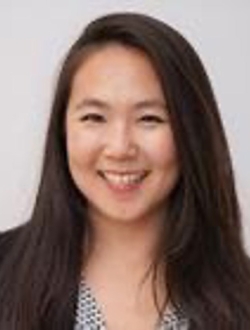 Smiling woman with long black hair.