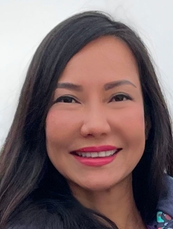 Smiling woman with long dark brown hair.