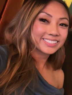 Smiling woman with long light brown hair.