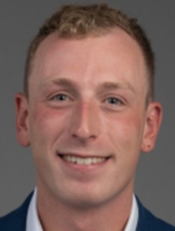Smiling man with short blond hair.