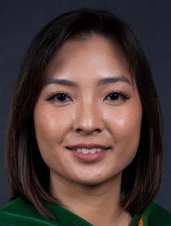 Smiling woman with shoulder length dark brown hair.