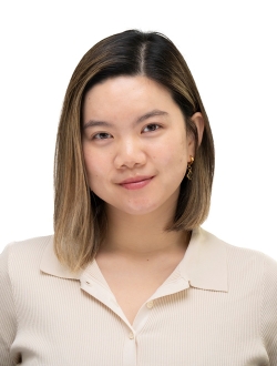 Person with shoulder length light brown hair wearing a beige shirt.
