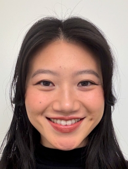Smiling person with long black hair.