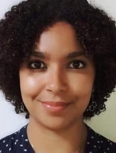 Person with short black curly hair.