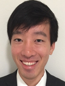 Smiling person with short black hair.