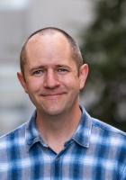 man in blue shirt smiling