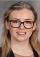 Smiling woman with long blonde hair and glasses.