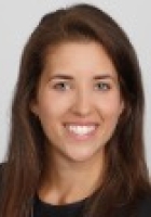 Smiling woman with long brown hair.