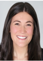 Smiling woman with long brown hair.