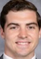 Smiling man with short brown hair.