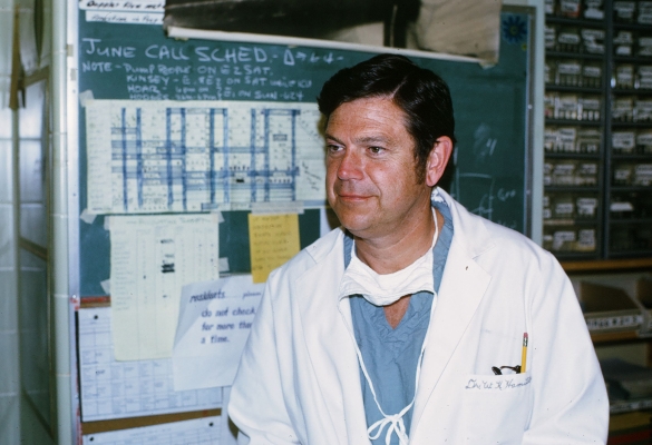 Dr. Bill Hamilton in white coat and scrubs.