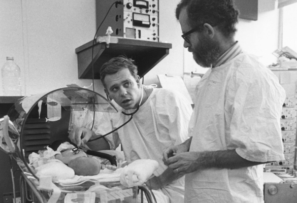 Dr. George Gregory and colleague check on a baby.