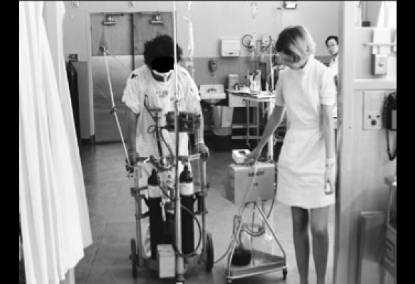 A nurse walks with a patient in the SFGH ICU.