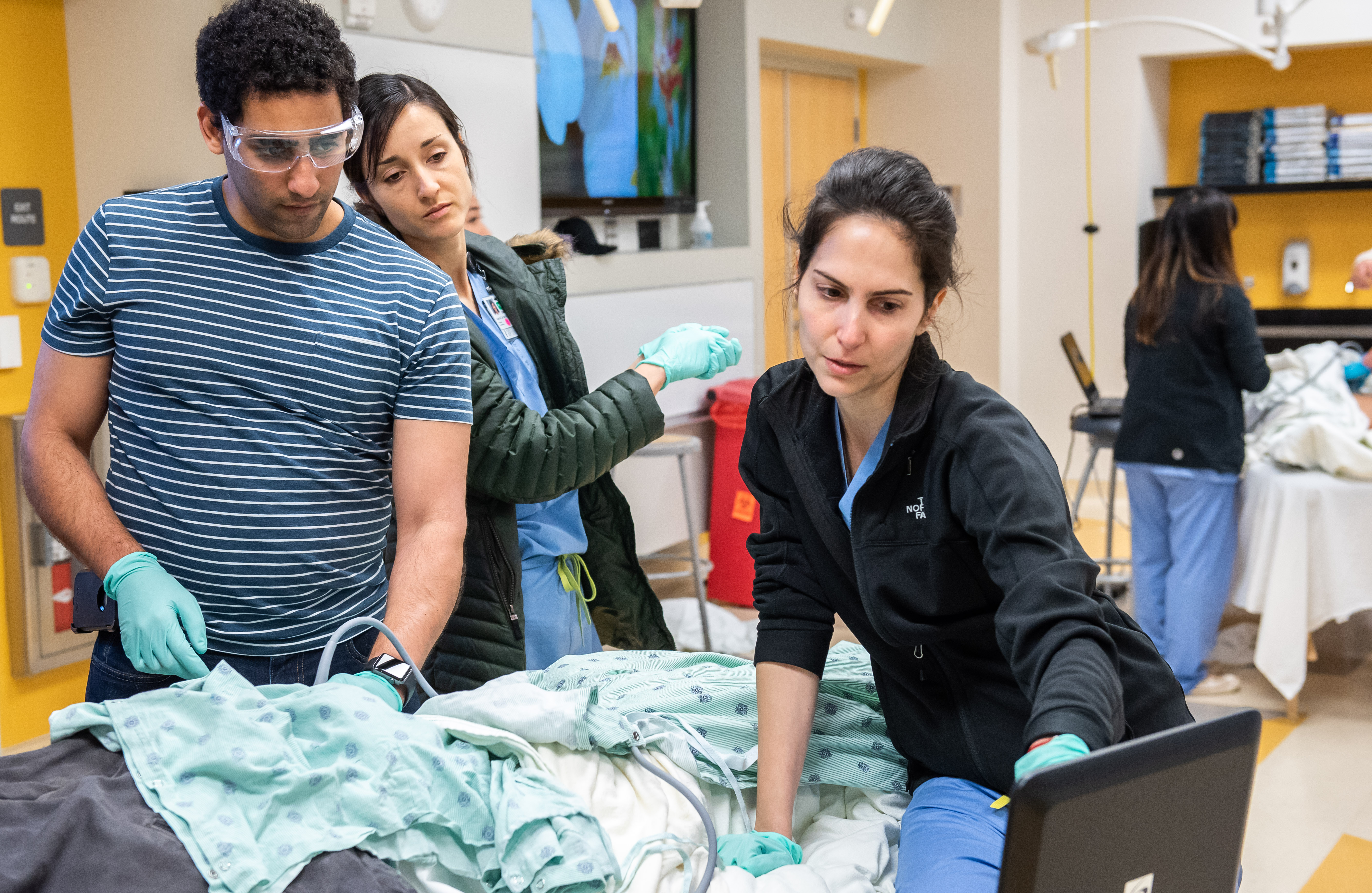 Andrew Bishara, Valeria Carcamo Cavazos, and Iman Hadaya perform a patient ultrasound